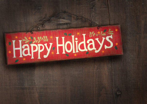 Holiday sign on distressed wood wall