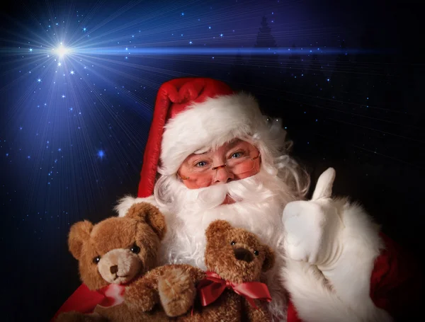 Santa lachende bedrijf toy teddyberen — Stockfoto