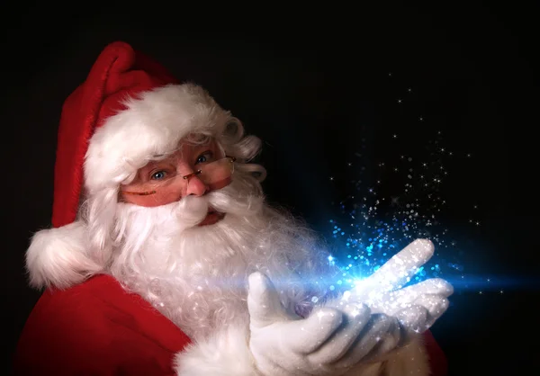 Santa κρατώντας μαγικό φώτα στα χέρια — Φωτογραφία Αρχείου