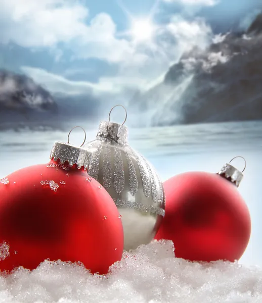 Three red Christmas balls in the snow — Stockfoto