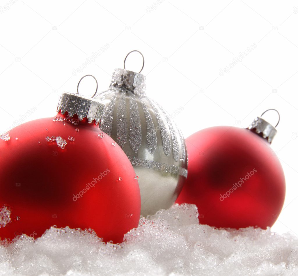 Three red Christmas balls in the snow