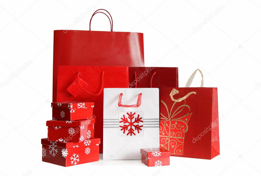 Various sizes of holiday shopping bags and gift boxes on white