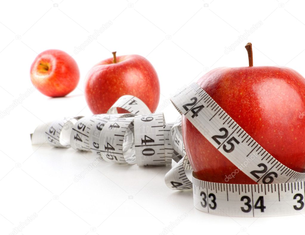 Red apples and measuring tape on white background