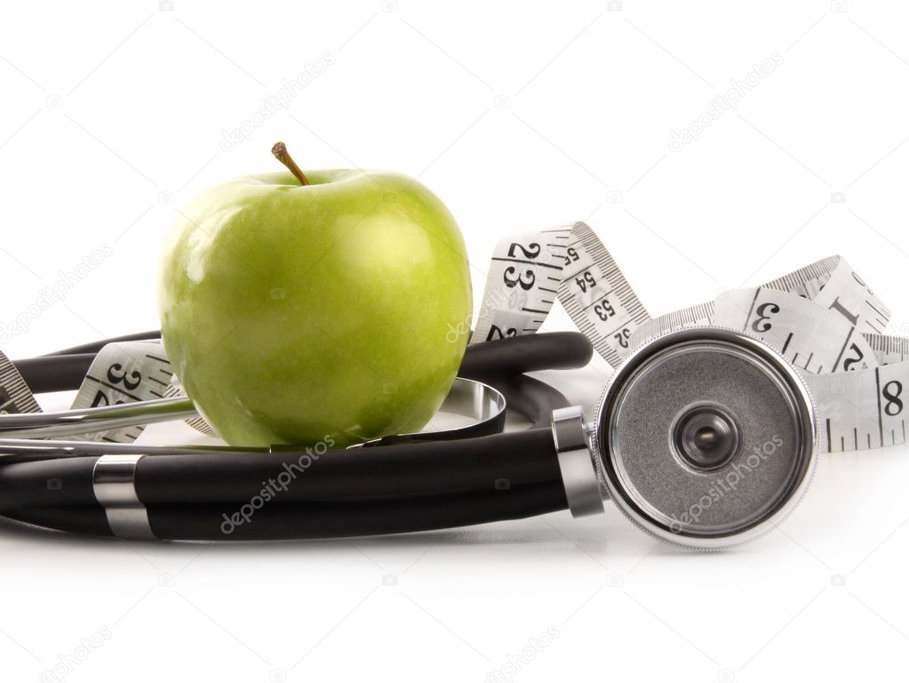 Green apple and measuring tape with stethoscope on white background