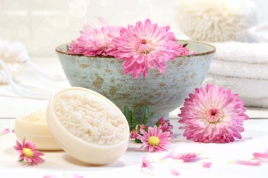 Spa scene with pink chrysanthemum flowers in water and soap clipart