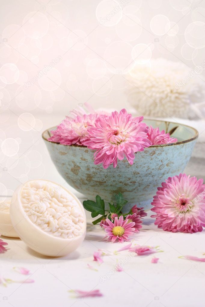 Spa scene with chrysanthemum flowers in water and soap