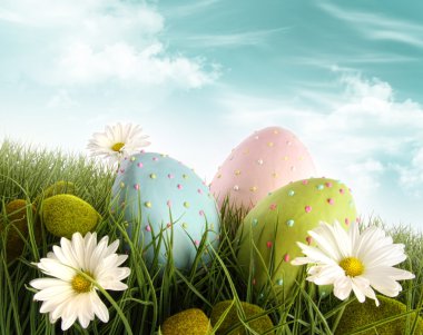 Decorated easter eggs in the grass with daisies clipart