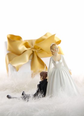 Wedding cake figures with gift on white clipart