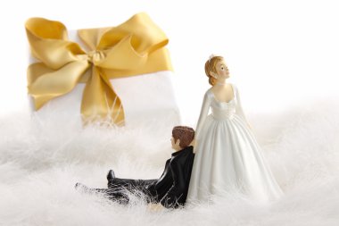 Wedding cake figurines with gift on white clipart