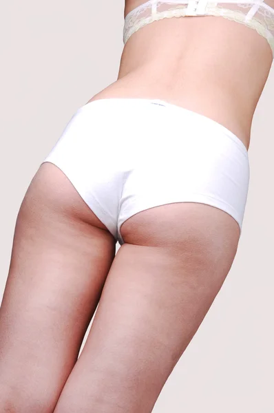 The back of a girl in a white panties. — Stock Photo, Image