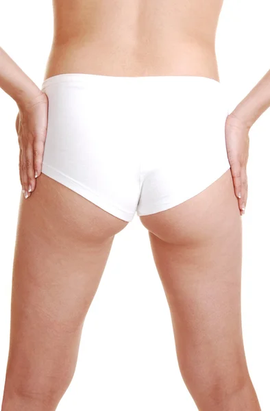 De achterkant van een meisje in een witte panty. — Stockfoto