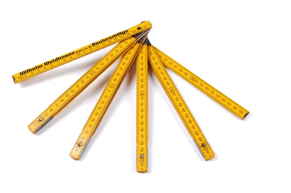 stock image An foldable yellow European ruler, two meter long, on white background.