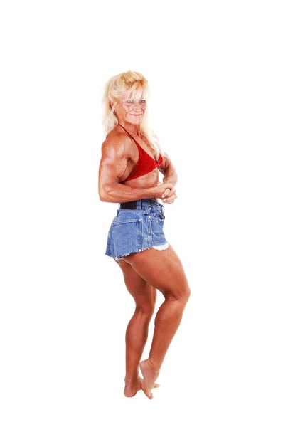 彼女の強力な足 上半身や腕 白い背景の上に Shooing スタジオで立っている金髪の筋肉ボディービル女の子 — ストック写真
