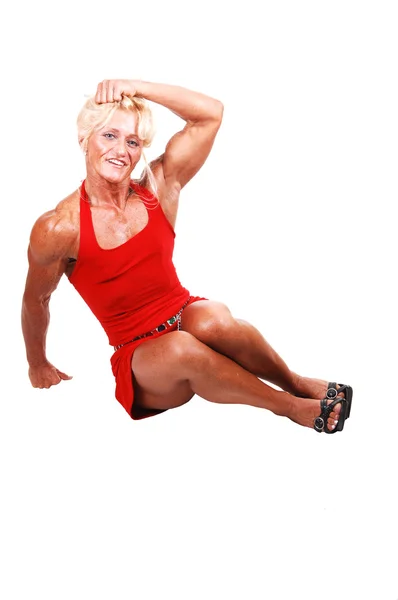 Blond Bodybuilding Girl Sitting Studio Red Dress Shooing Her Very — Stock Photo, Image
