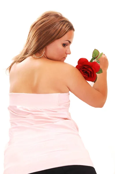 可爱的女孩在短的粉色裙子和红色的头发 躺在地板上 一朵红玫瑰 寻找到一边 白色背景上 — 图库照片