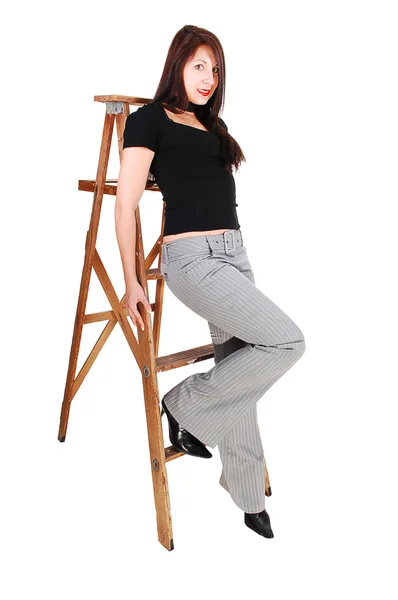 Young Woman Sitting Step Stepladder Gray Dress Pants Black Sweater — Stock Photo, Image