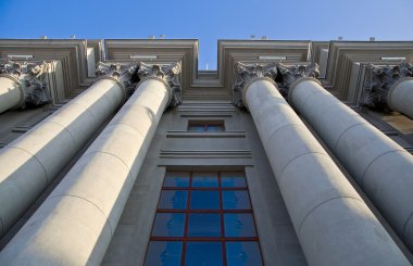 Stalinist architecture. Corinthian capitals and columns. Prospectively on a background of blue sky. clipart