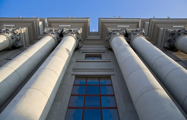 stock image Stalinist architecture. Corinthian capitals and columns. Prospectively on a background of blue sky.