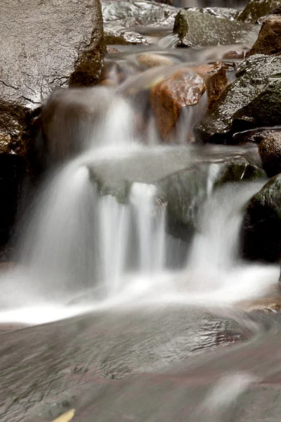 stock image Cascade falls over old plum river with rocks