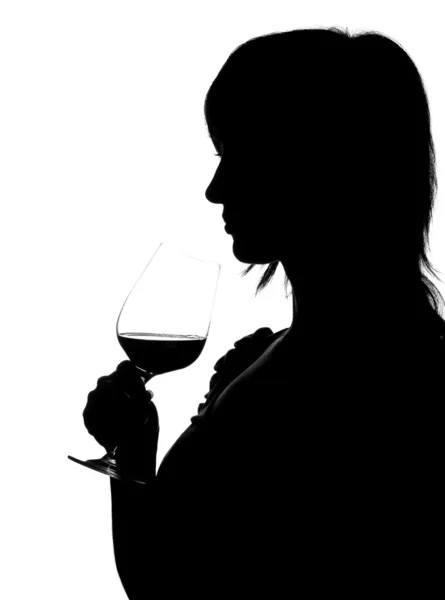 Silhouette of woman smelling red wine — Stock Photo, Image