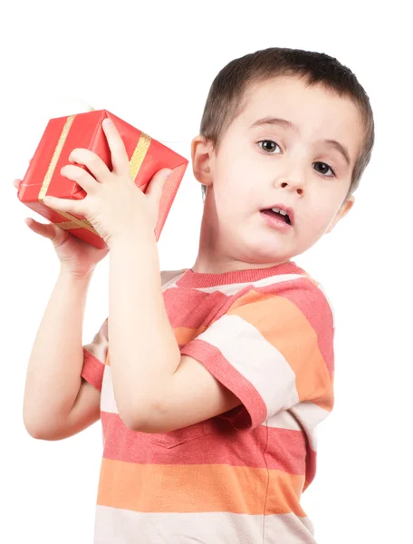 Little boy shakes gift box — Stock Photo, Image
