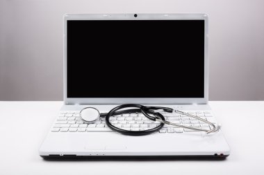 Stethoscope and white laptop clipart