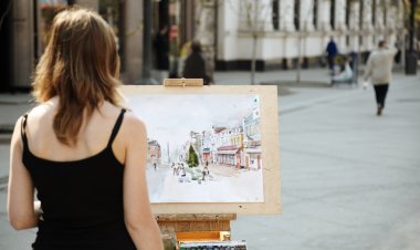 Young woman painting outside, focus point on image clipart