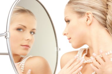 Beautiful woman with pearl beads and mirror clipart