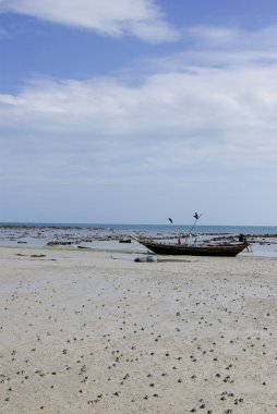 Boat on beach with nice sky