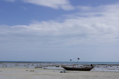 Boat on beach with nice sky