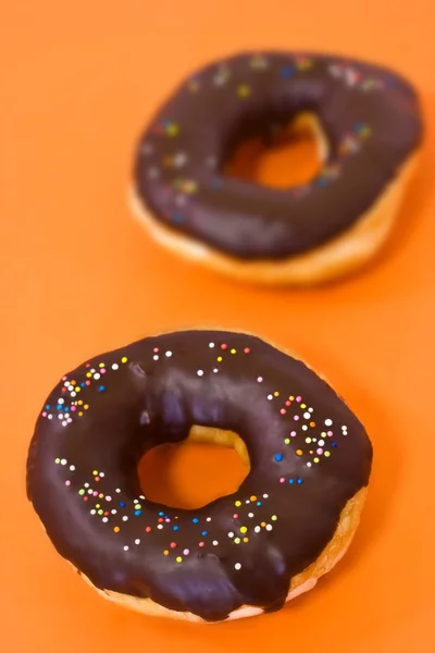 Coco doughnut on orange background — Stock Photo, Image
