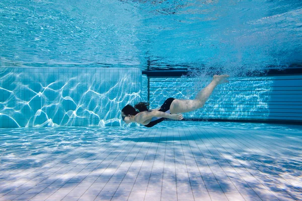 stock image A young girl after the jump float under water