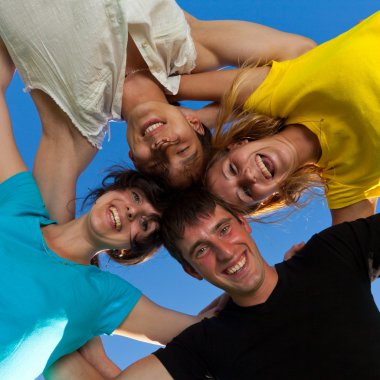 Below view of joyful teens embracing and looking at camera with clipart