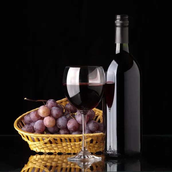 Una bottiglia di vino rosso, vetro e uva — Foto Stock