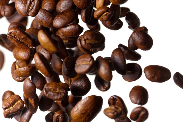 Falling coffee beans on white background — Stock Photo, Image