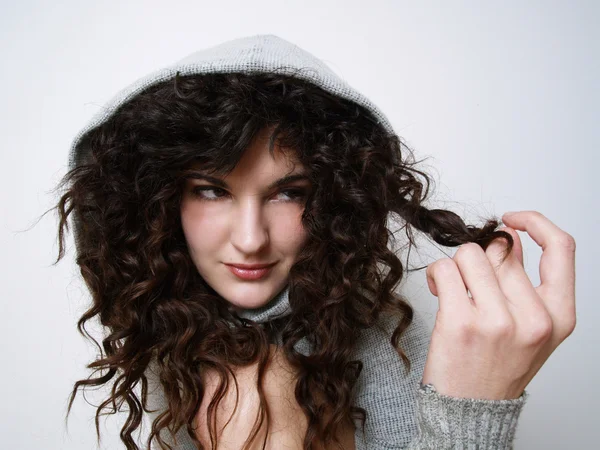 stock image Young girl in hood playing with her hair