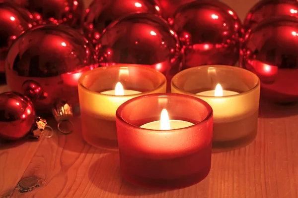 Red Christmas balls and candles — Stock Photo, Image