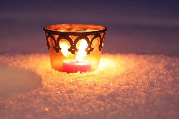 Burning candle in the snow — Stock Photo, Image