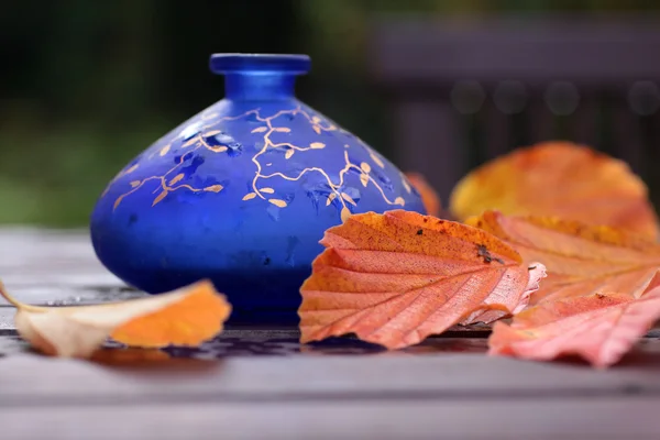 Blue vase with autumn decorations — Stock Photo, Image
