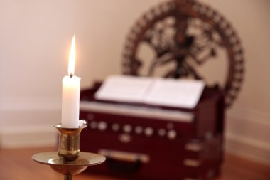 Candle and harmonium clipart