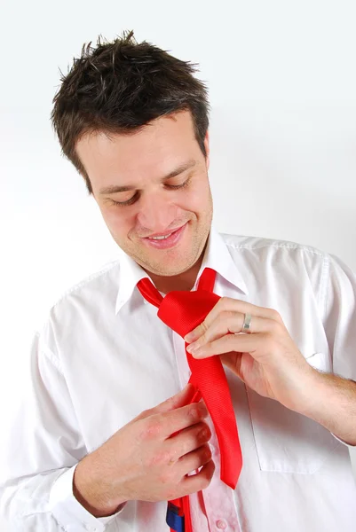 Homem amarrando uma gravata vermelha — Fotografia de Stock
