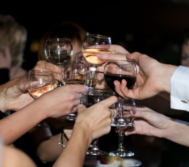 Many hands with glasses of red and white wine clipart