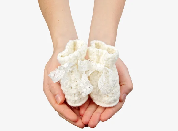 stock image Woman's hands with baby's bootee