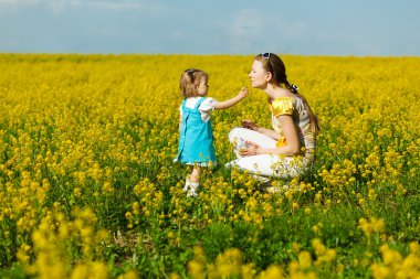 Mother with baby on field clipart