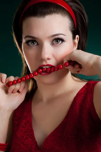 Bite the red beads — Stock Photo, Image