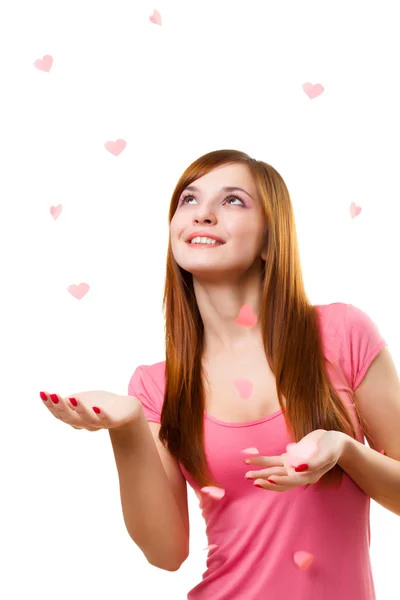 Young woman catching paper hearts — Stock Photo, Image