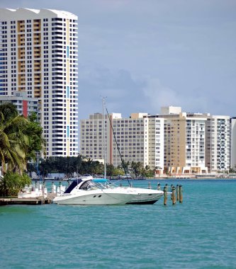 Miami Beach Condos and a Cabin Criser on Biscayne Bay clipart