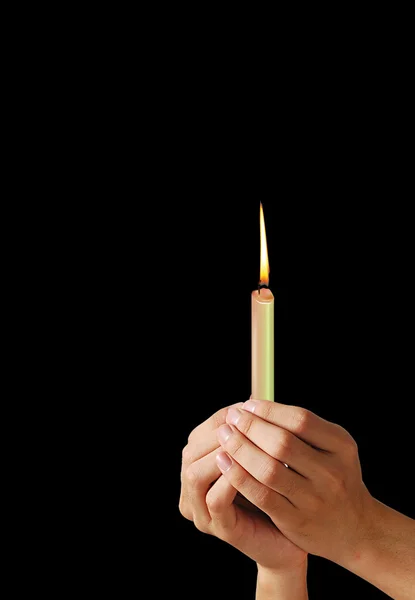 Hände und eine Kerze — Stockfoto