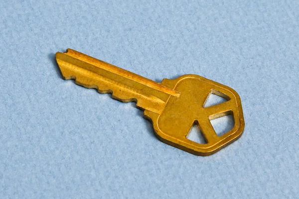 stock image Yellow like golden key on blue background