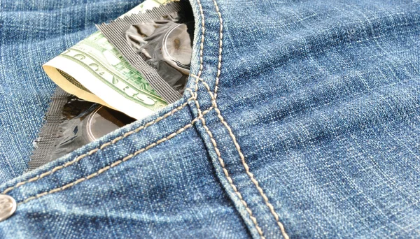 Condoms and money in pocket — Stock Photo, Image
